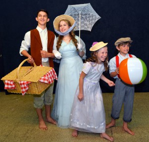 The actors in the photograph are, from left to right: Gabriel Ferrari (Caractacus Potts); Natalie Minter (Truly Scrumptious); Charlotte Wearne (Jemima Potts); and Luke Wilborn (Jeremy Potts).