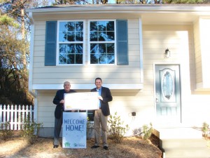 Jackson EMC Foundation board member Jim Puckett presents a $15,000 Foundation grant check to Habitat for Humanity of Gwinnett County’s Executive Director Brent Bohanan.