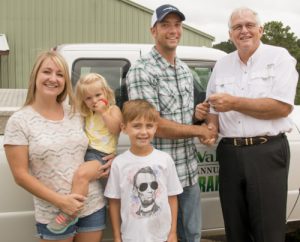 Walton EMC customer-owner Keith Stout of Monroe, second from right, receives the keys to the annual meeting grand prize, a recycled Ford pick-up truck from CEO Ronnie Lee.