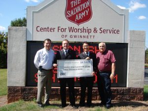 From left are Jackson EMC District Manager Randy Dellinger, Salvation Army Lt. Jeremy Mockabee, Salvation Army Lt. Minkee Kim and Jackson EMC Foundation board member Jim Puckett with a $15,000 Foundation grant check that will help fund the Family Emergency Services program that provides rent and mortgage assistance to prevent homelessness.