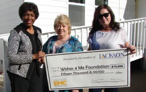 Jackson EMC Foundation board chair Beauty Baldwin (left) presents a $15,000 Foundation grant check to Wishes 4 Me Founder Lynn Robinette (center) and House Manager Tonya Ward that will be used to repair and expand a home for disabled adults so that they may live independently. 