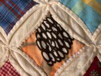 Note the intricate patchwork on this quilt.